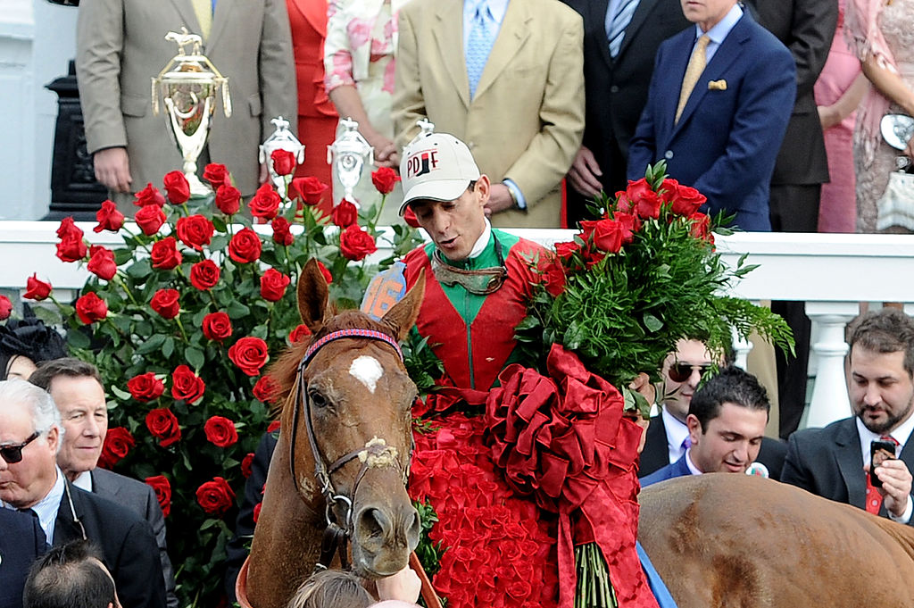 A horse wears a blanket of roses