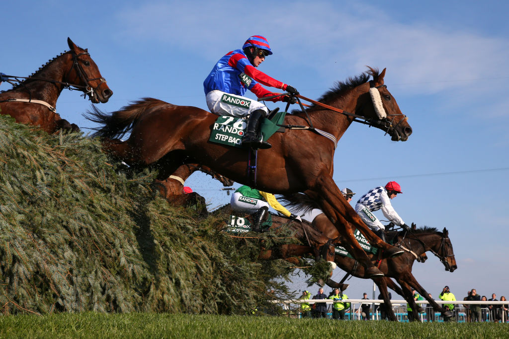 several jumping horses and their riders