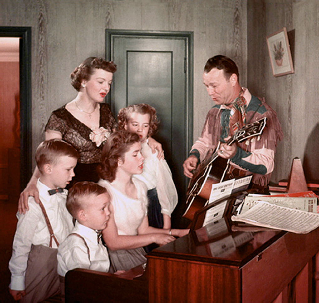 Roy Singing Around The Piano with children and family