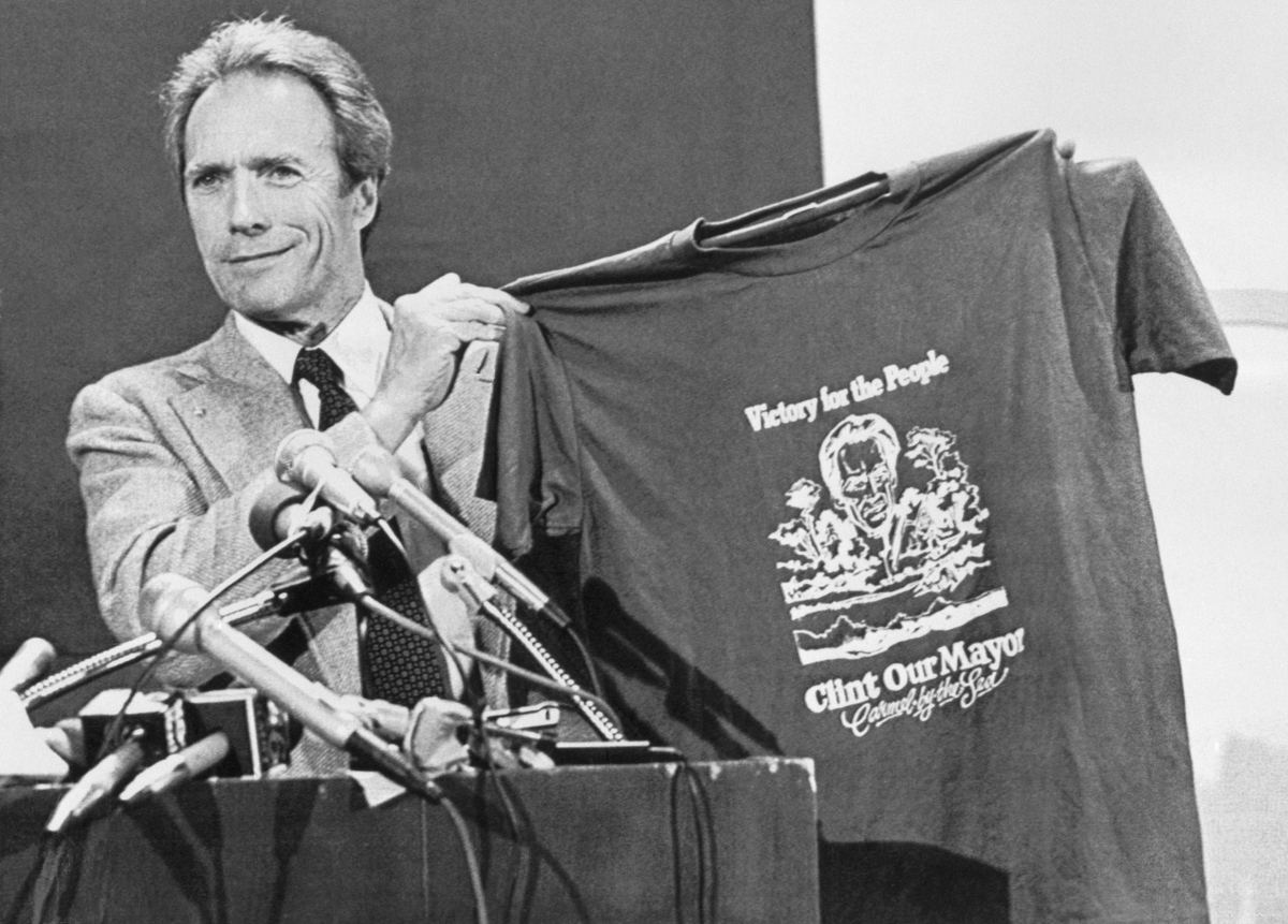 Clint Eastwood proudly holds up a t-shirt proclaiming him as the mayor of Carmel, California, during his acceptance speech on April 9, 1986.