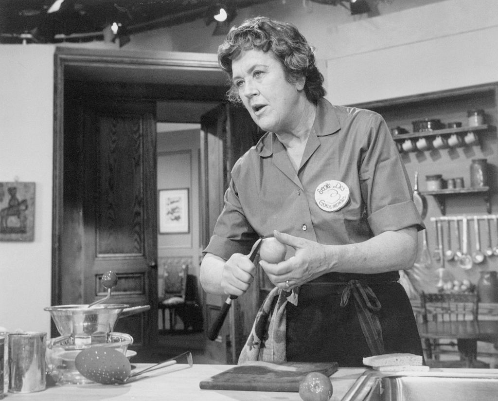 Julia Child, ebullient French chef, as she prepares a dish for a TV audience