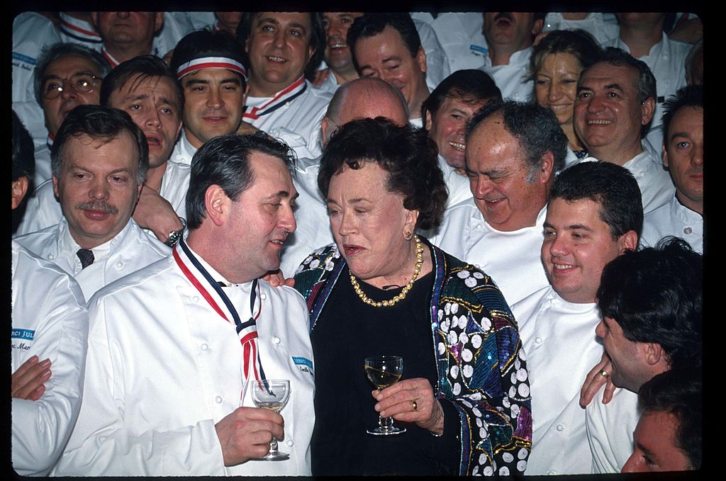 Julia Child speaks with an unidentified guest at a celebration dinner