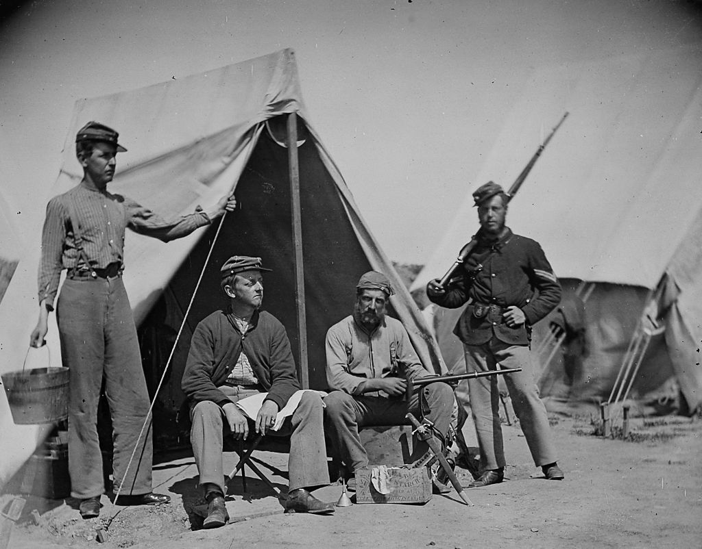 war soldiers lined up for a picture back in the day looking mighty