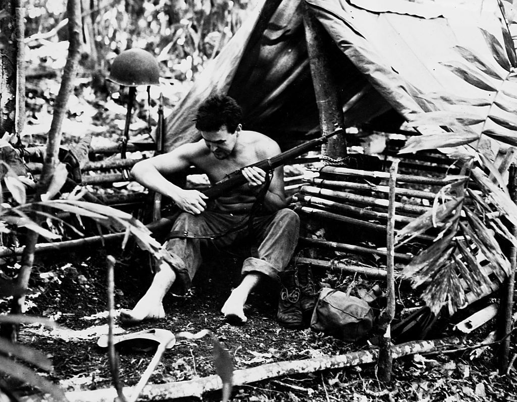 Marine in tropical dwelling, Guadalcanal, Solomon Island