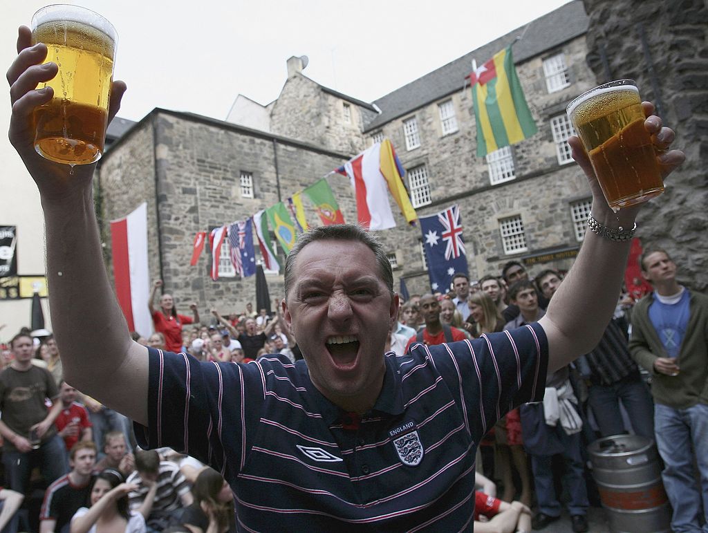 Trinidad and Tobago and England soccer fans react during a big screen viewing of the England v Trinidad and Tobago