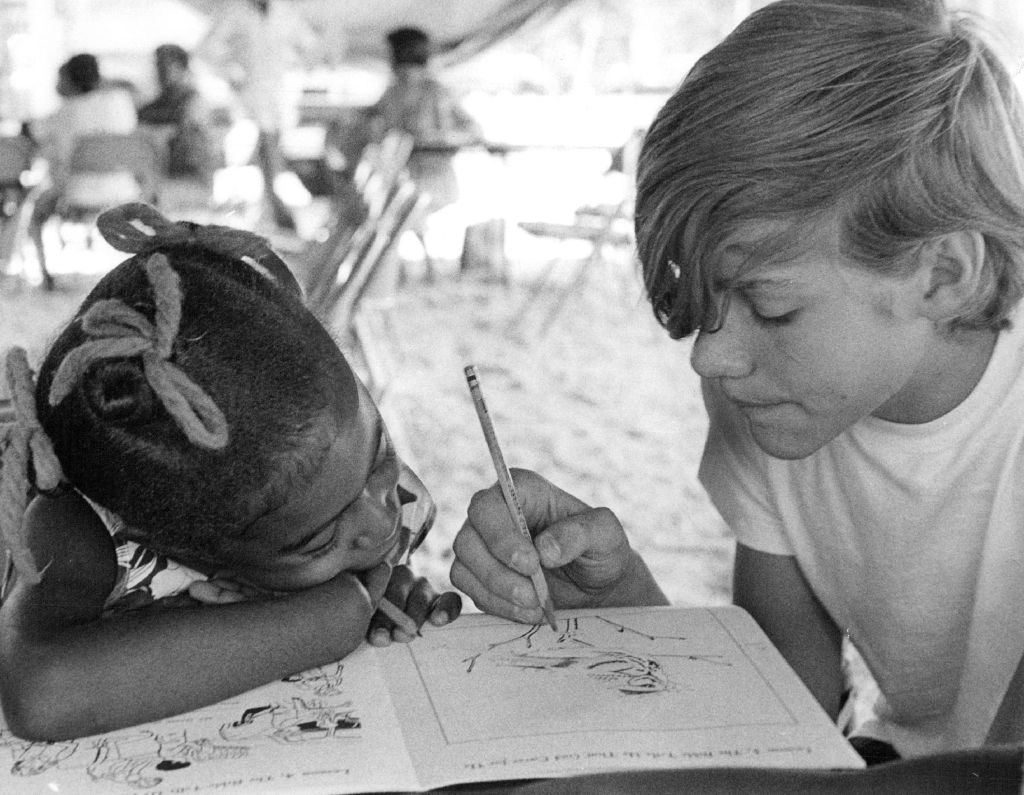 older kid volunteering to teach a younger child