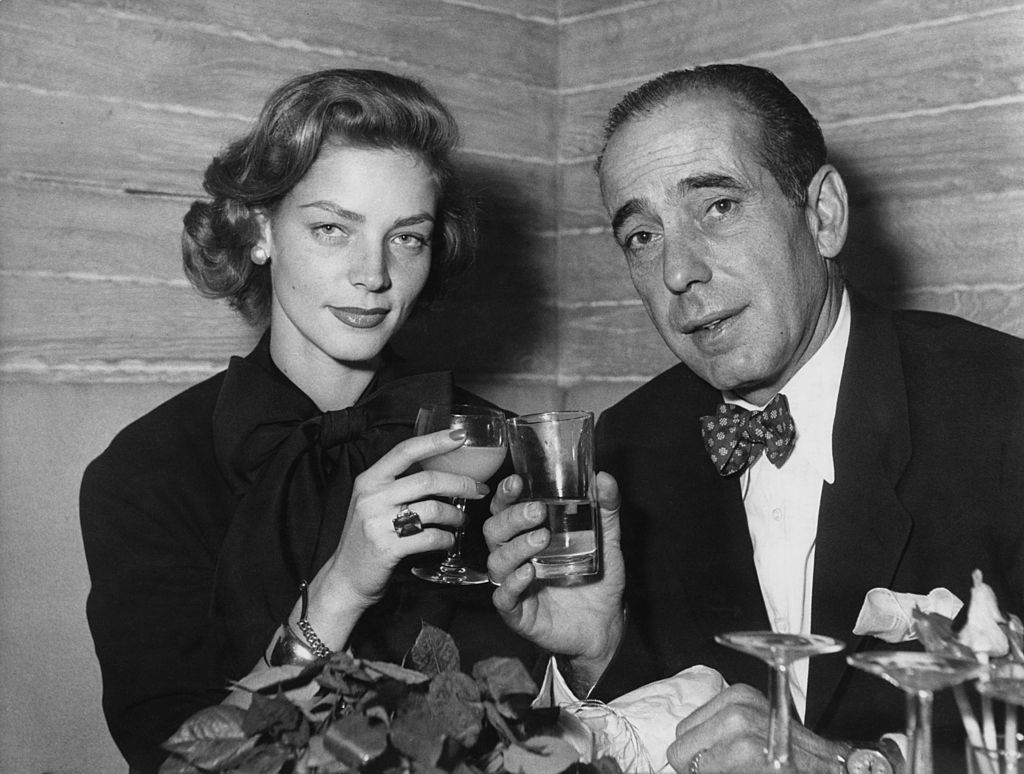 Bogart and Bacall raise a glass in toast