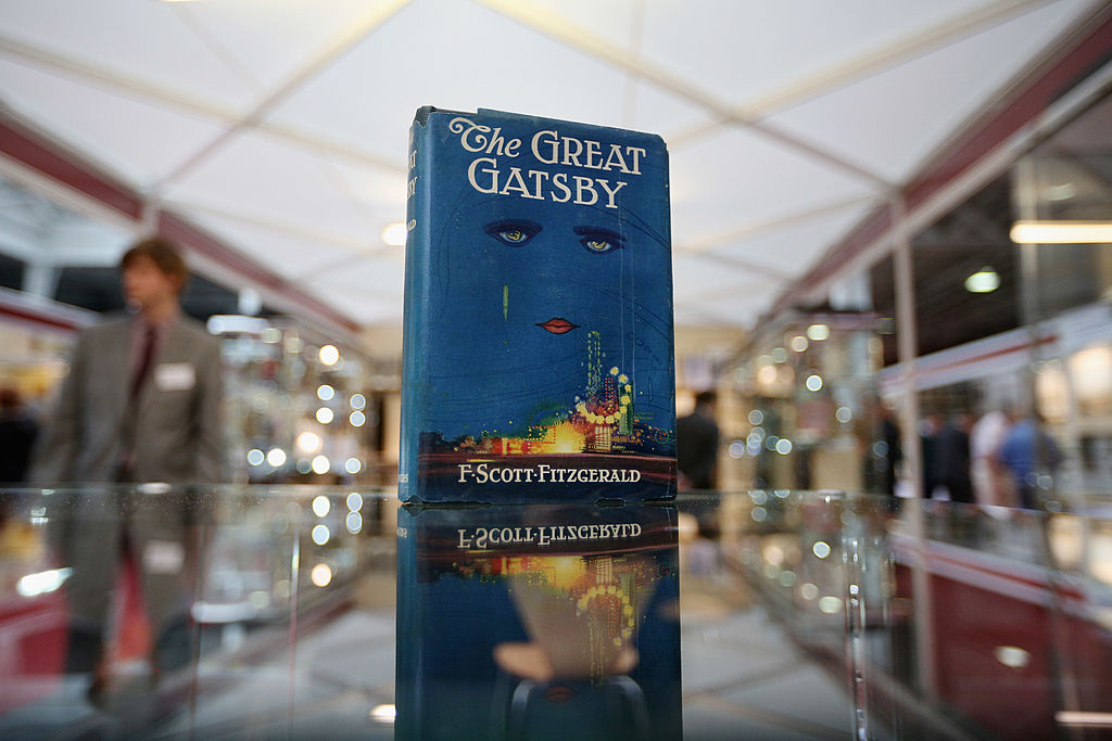 first edition of the great gatsby book displayed on a glass counter