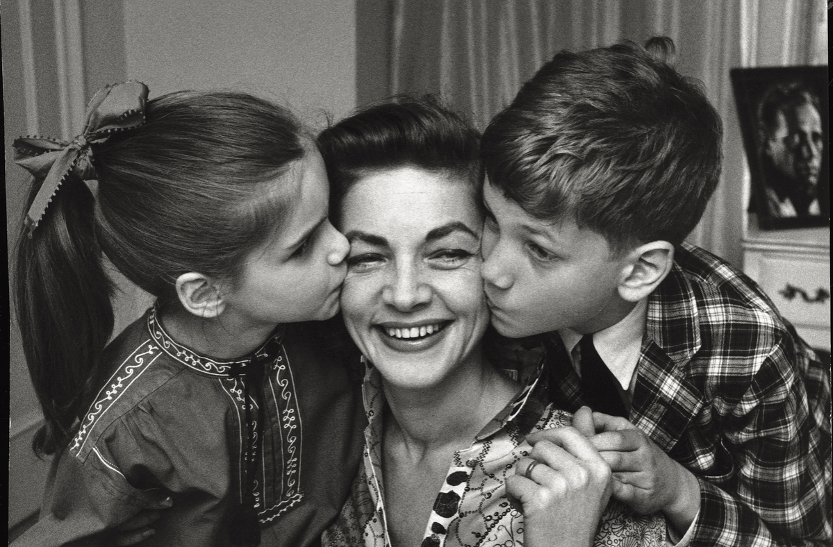 The American actress Lauren Bacall fondly plays with her children Leslie and Stephen