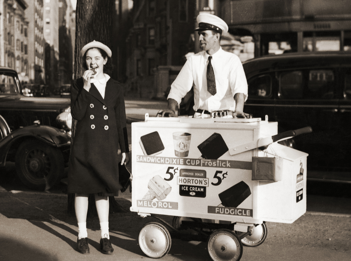Young girl enjoys ice cream sandwich from Hortons ice cream cart.