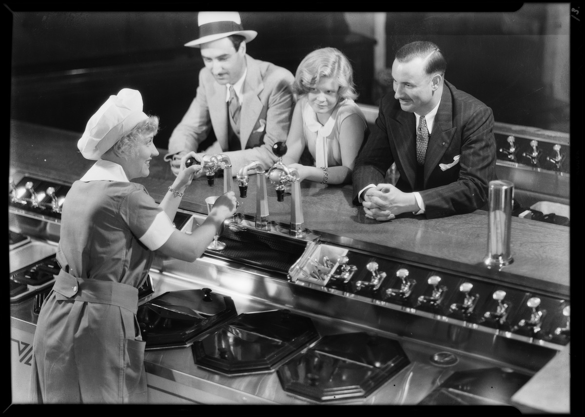 Men, women, and children in ice cream parlor, soda fountain shots, Weber Showcase & Co, Southern California, 1931.