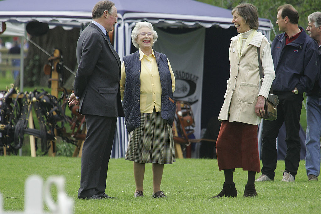 Queen Elizabeth II (C) enjoying the occasion with Michael Bullen, Chairman of the Windsor Horse Show and his wife Sally o