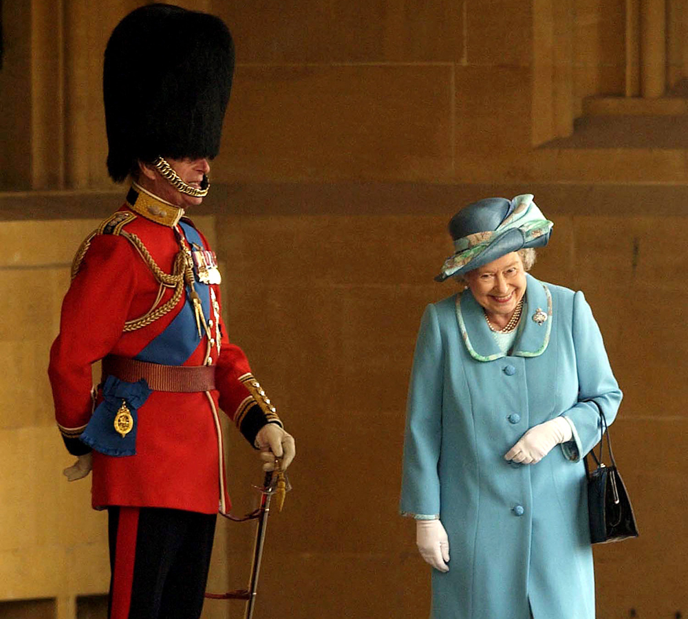  Queen Elizabeth II gets a fit of the giggles as she walks past her husband Prince Philip, the Duke of Edinburgh