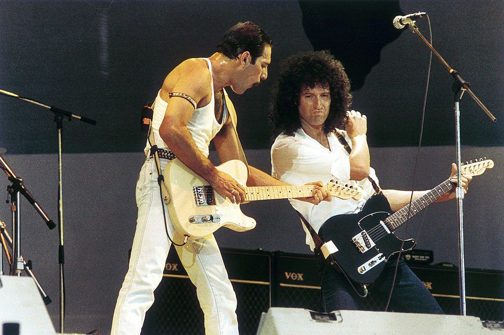 freddie mercury and brian may of queen performing on stage at live aid
