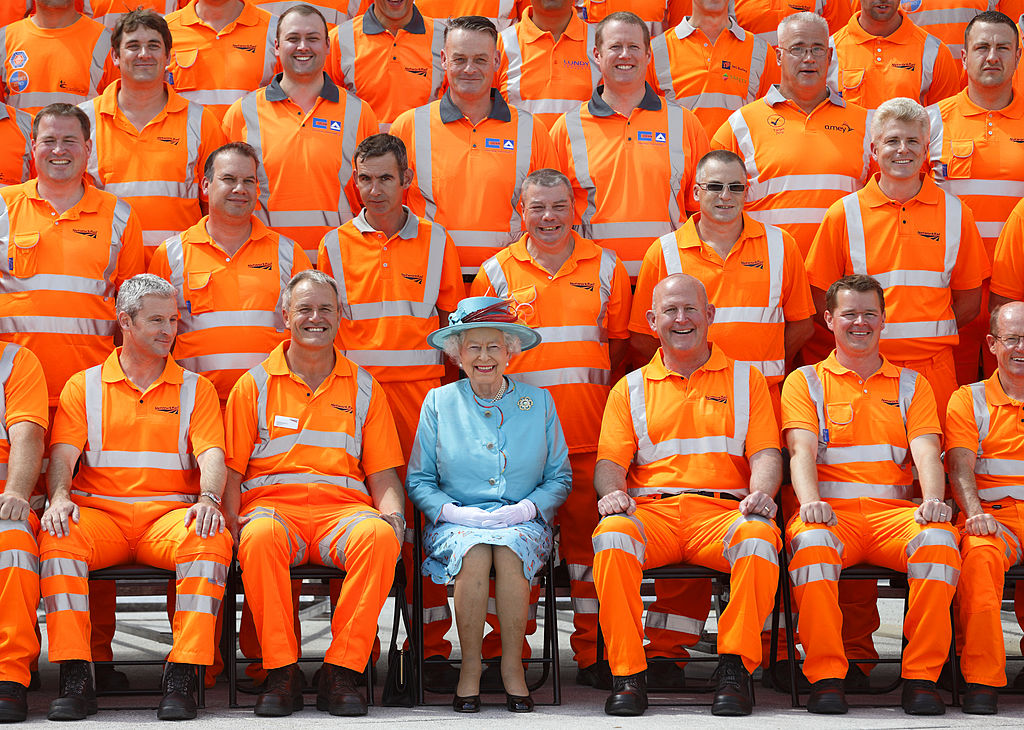 Queen Elizabeth II poses for a group photograph with Network Rail construction workers after opening the newly redeveloped Reading Railway Station