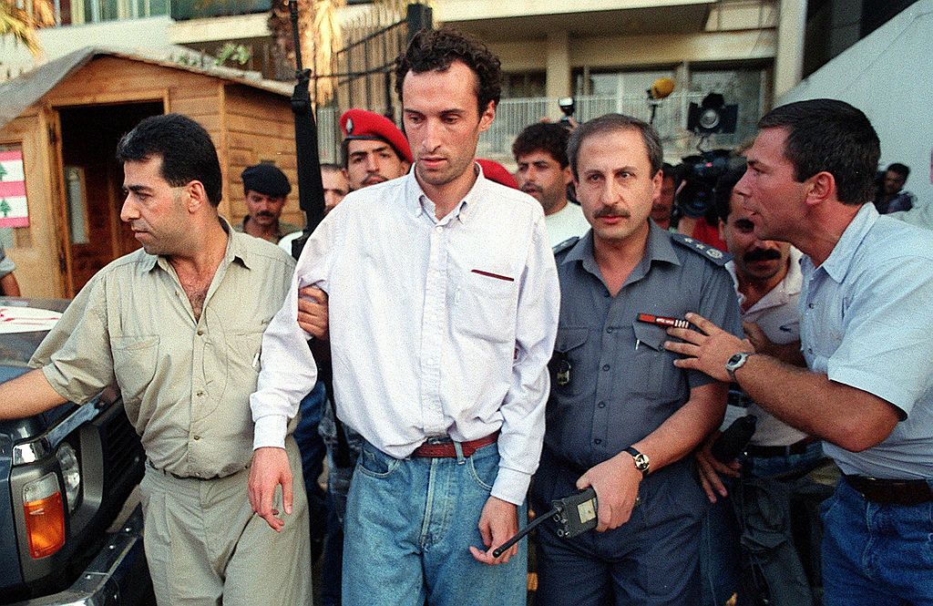 Frenchman Jerome Leyraud is crowded by onlookers as he is freed by Lebanese security.