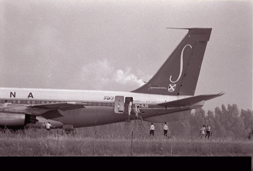 Passengers are escorted off of flight 571 once the landed plane has become secured.