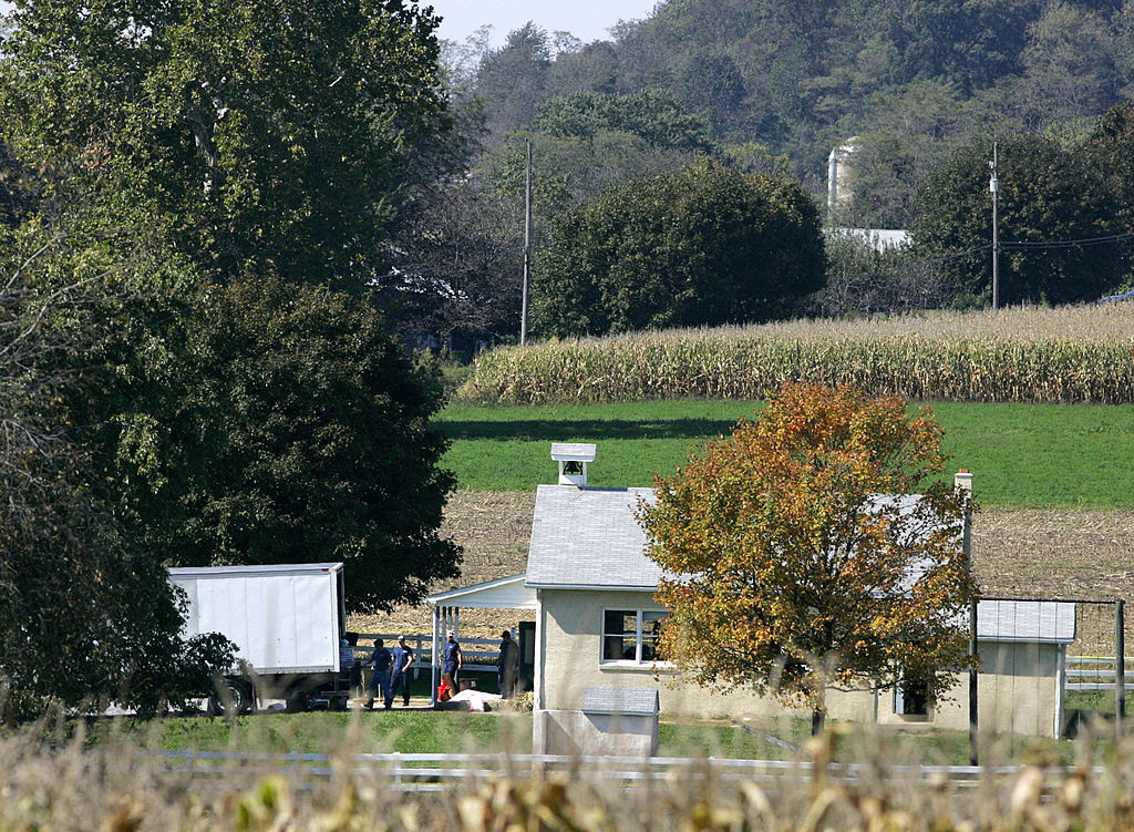 Officers exit the small schoolhouse once the ordeal has ended.