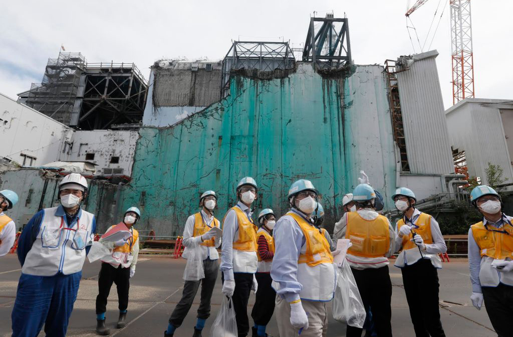 Standing in front of power plant