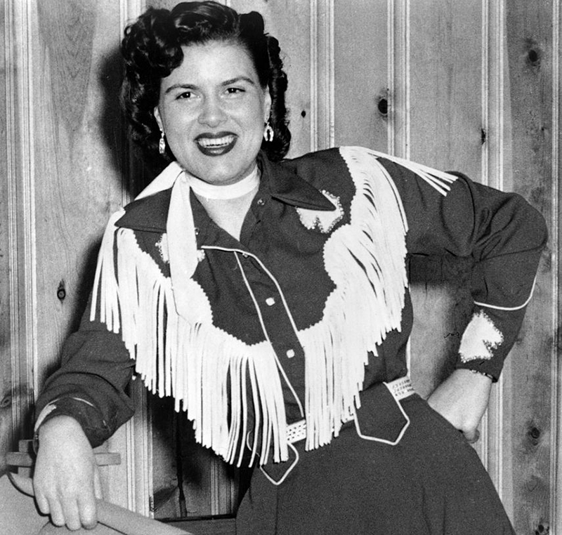 Patsy smiles while dressed like a cowgirl