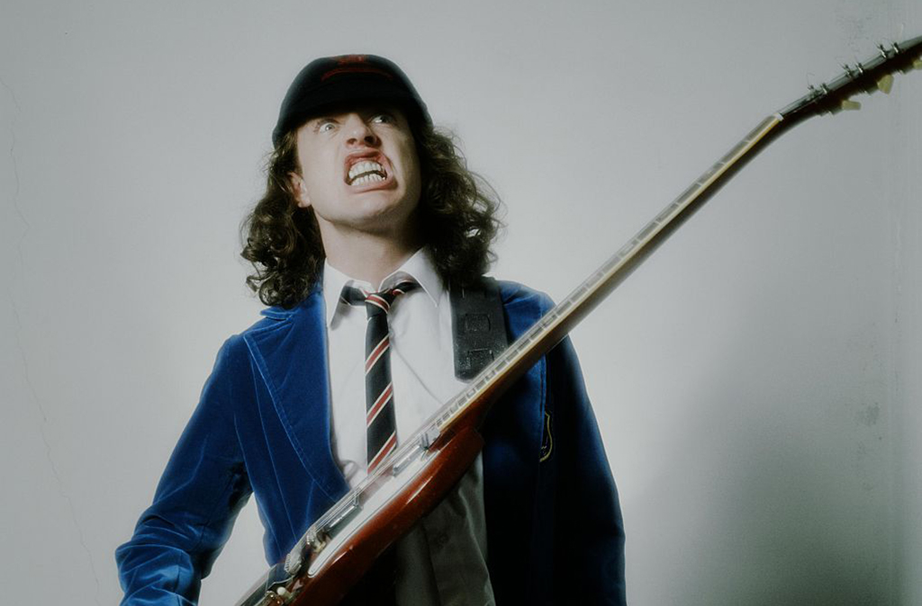 Angus Young posing for a picture