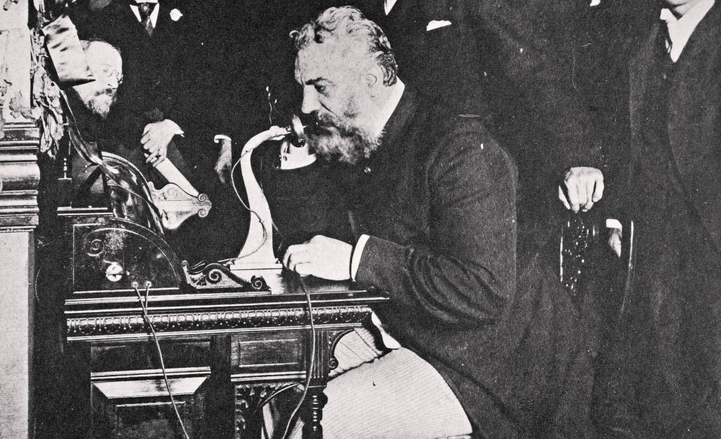 Alexander Graham Bell making the first telephone call