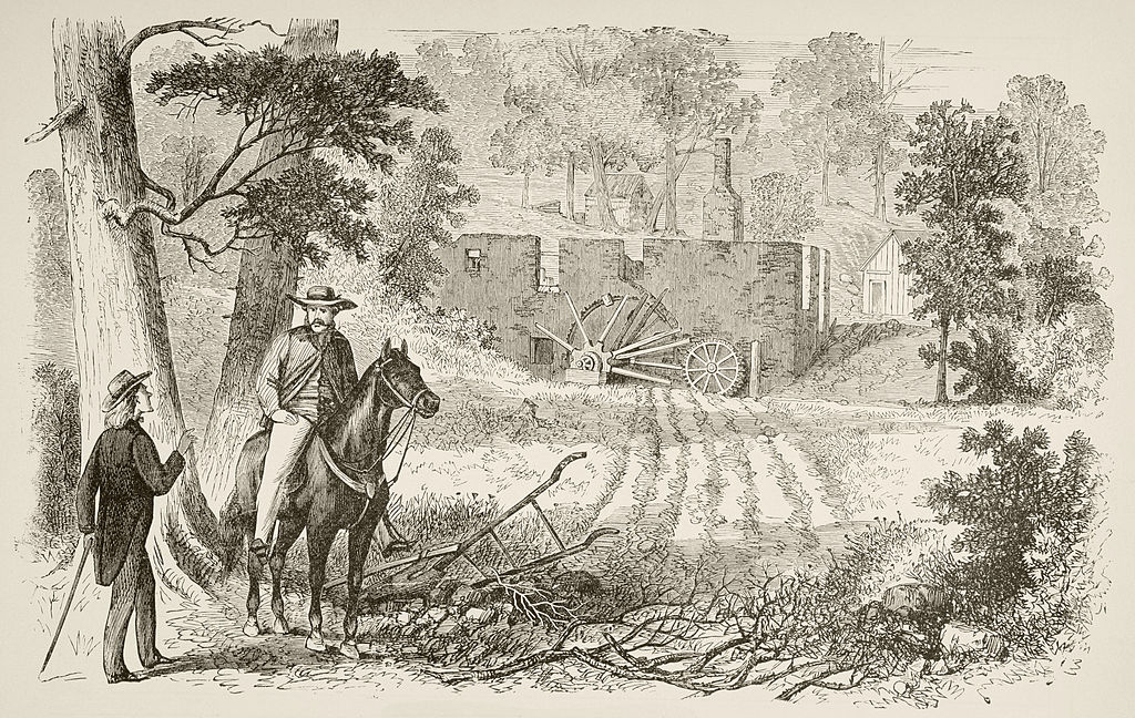 A man converses with another man who is on horseback.