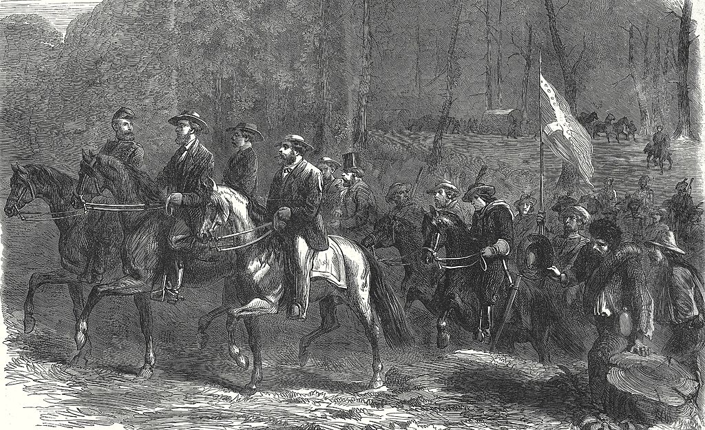 Men ride horses and carry a Confederate flag.