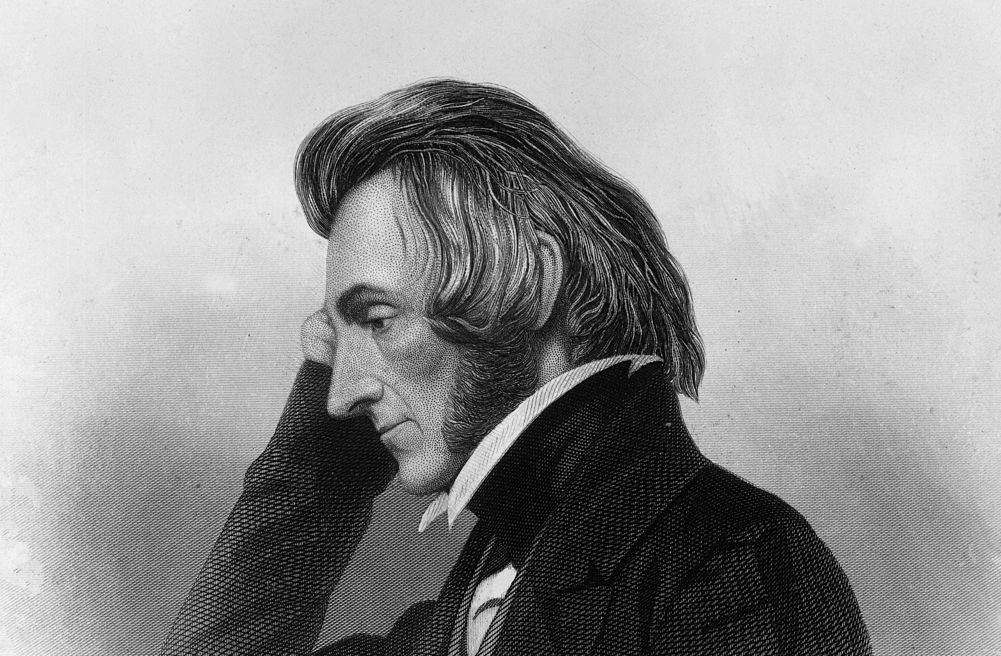 A profile photo of a man shows him resting his head in his hand.
