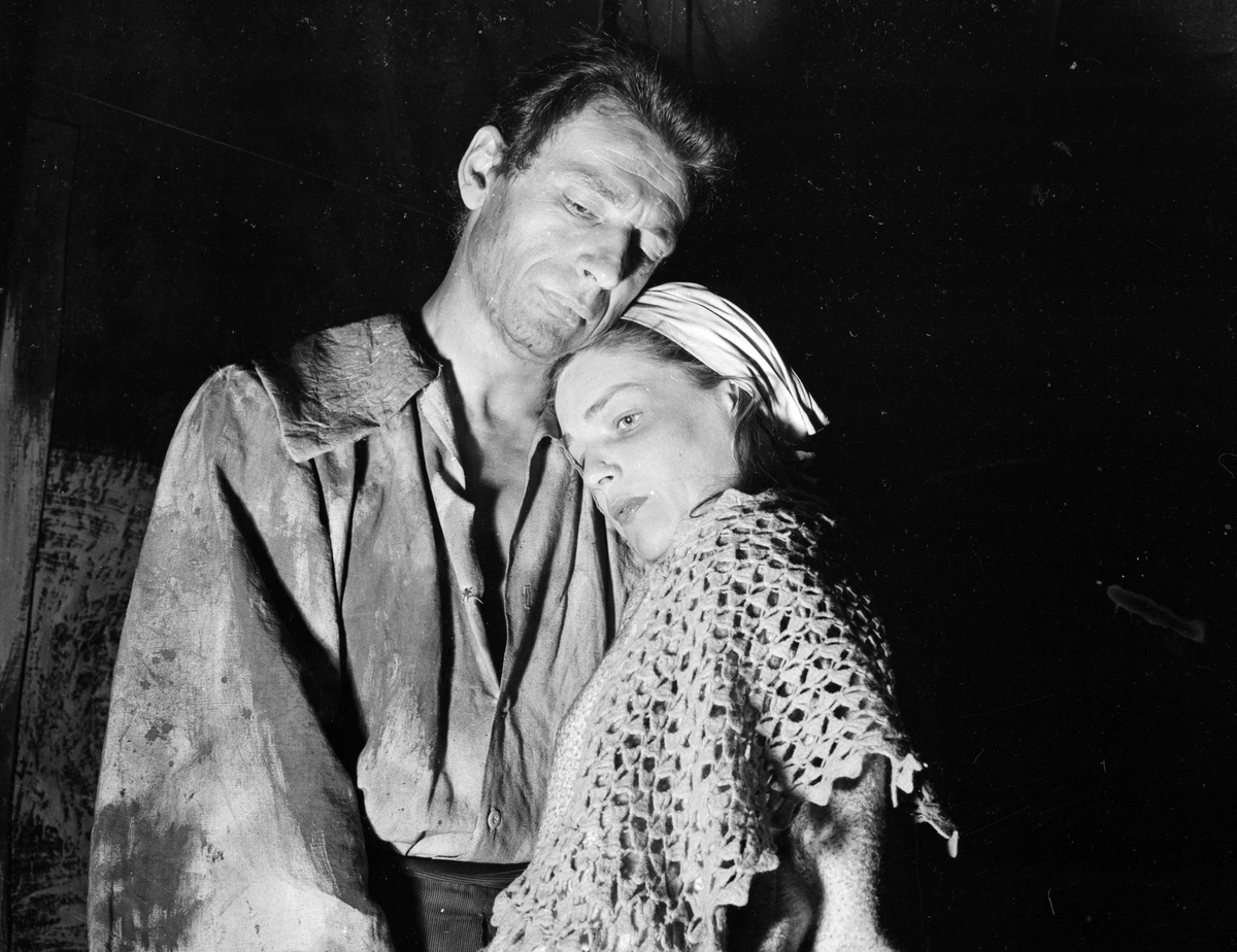 Real-life couple Yves Montand and Simone Signoret play John and Elizabeth Proctor in a production of Arthur Miller's stage play 'The Crucible'