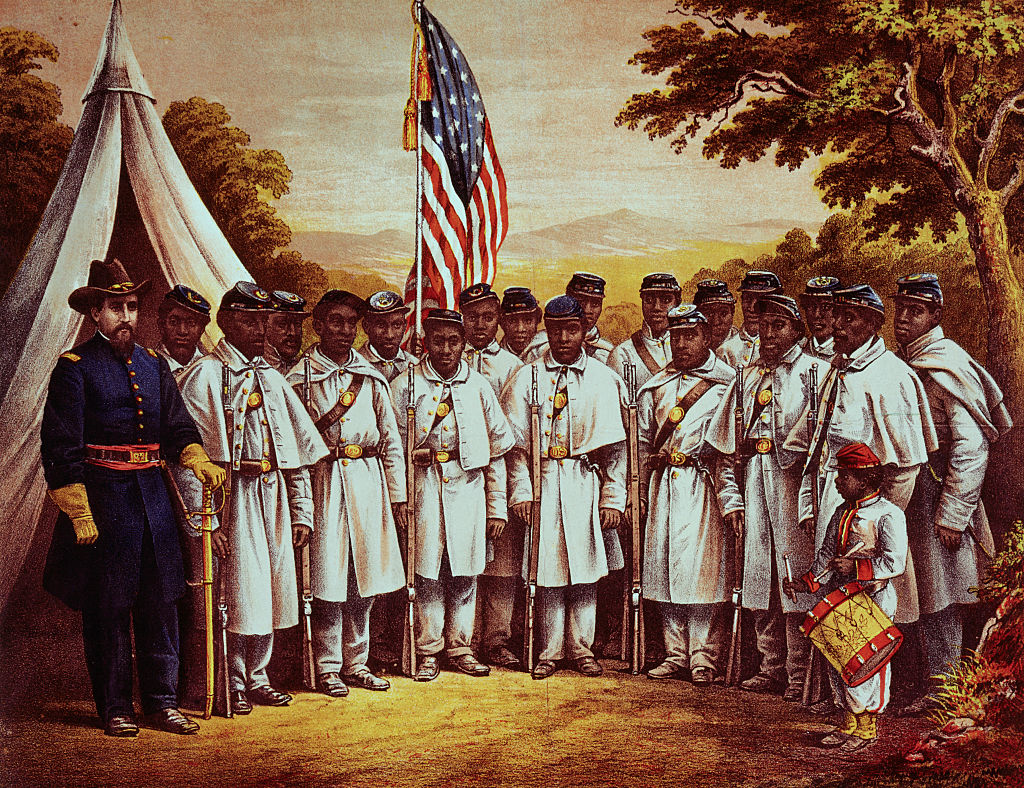 A group of American American soldiers are photographed next to a general.
