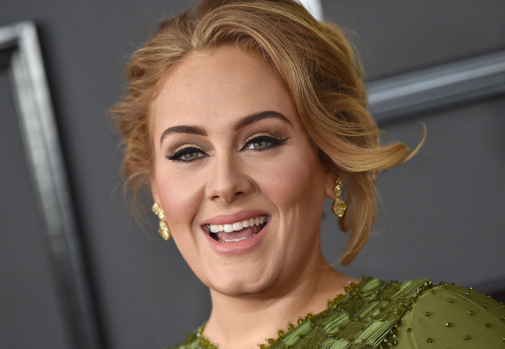 adele on the red carpet for the grammy awards in a green dress