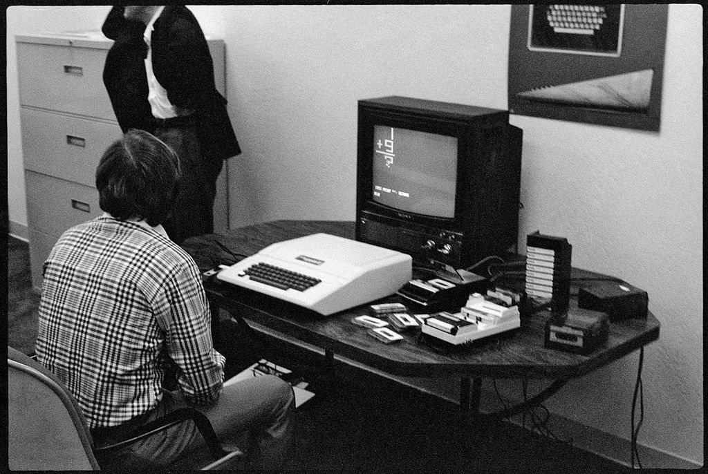Businessman Mike Markkula (born Armas Clifford Markkula Jr sits at a desk