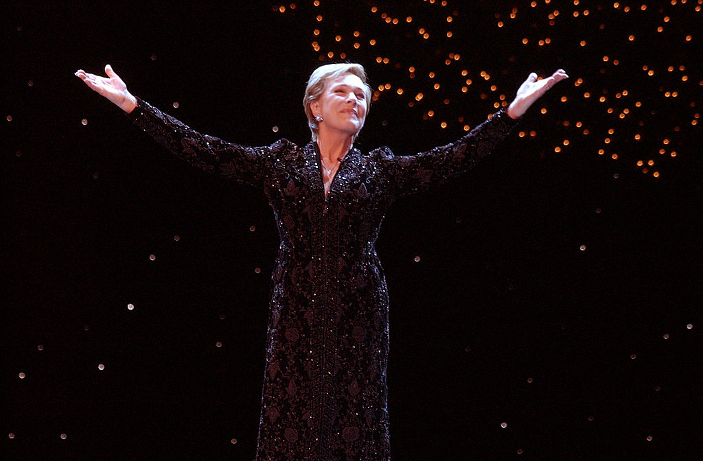 Julie Andrews spreads her arms while onstage during a Christmas performance.