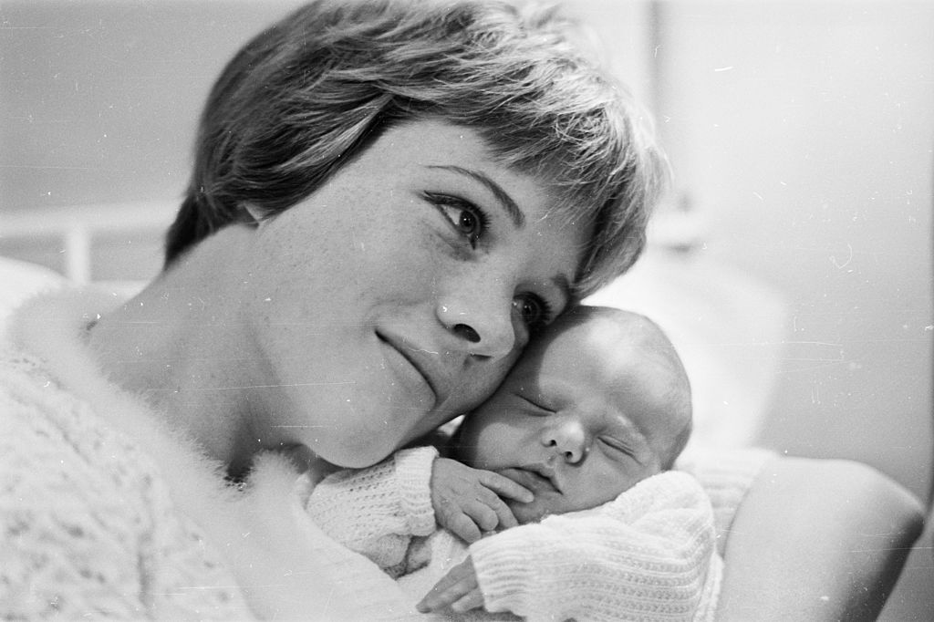 Andrews holds her newborn, Emma.