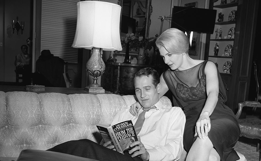 Newman reading a book with his wife