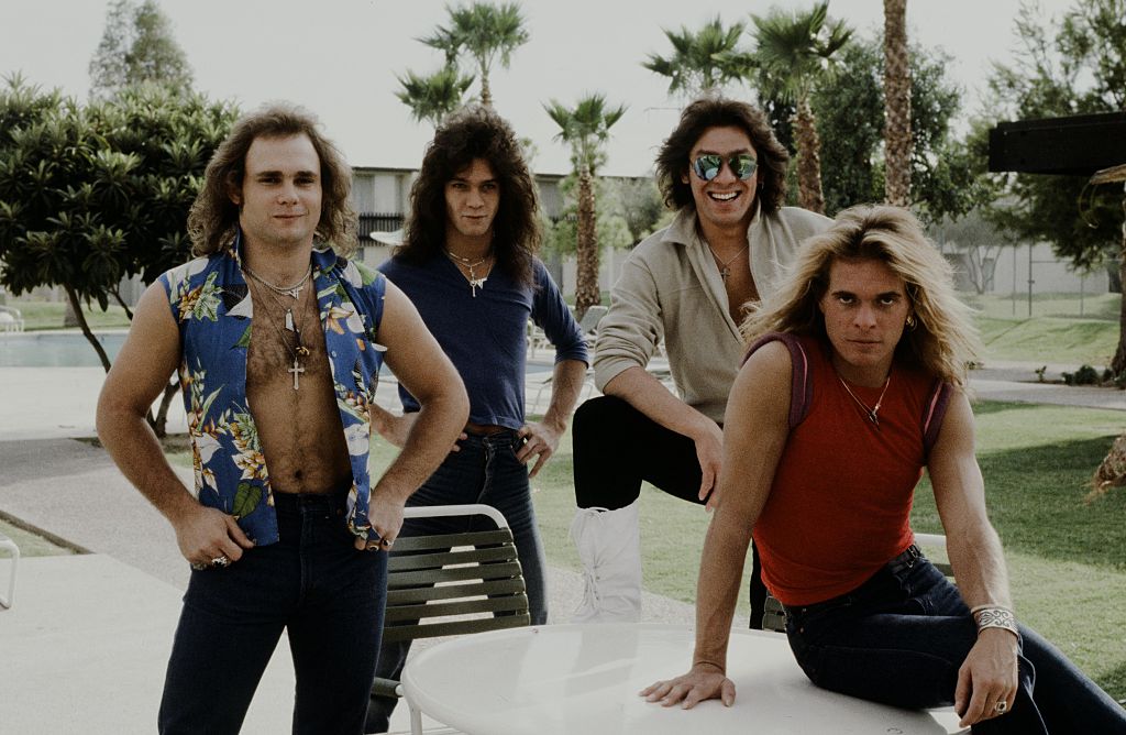 Van Halen posing on a car