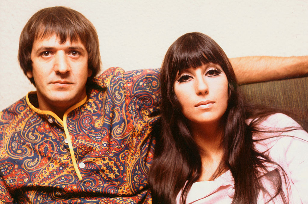 Sonny and Cher sitting on a couch
