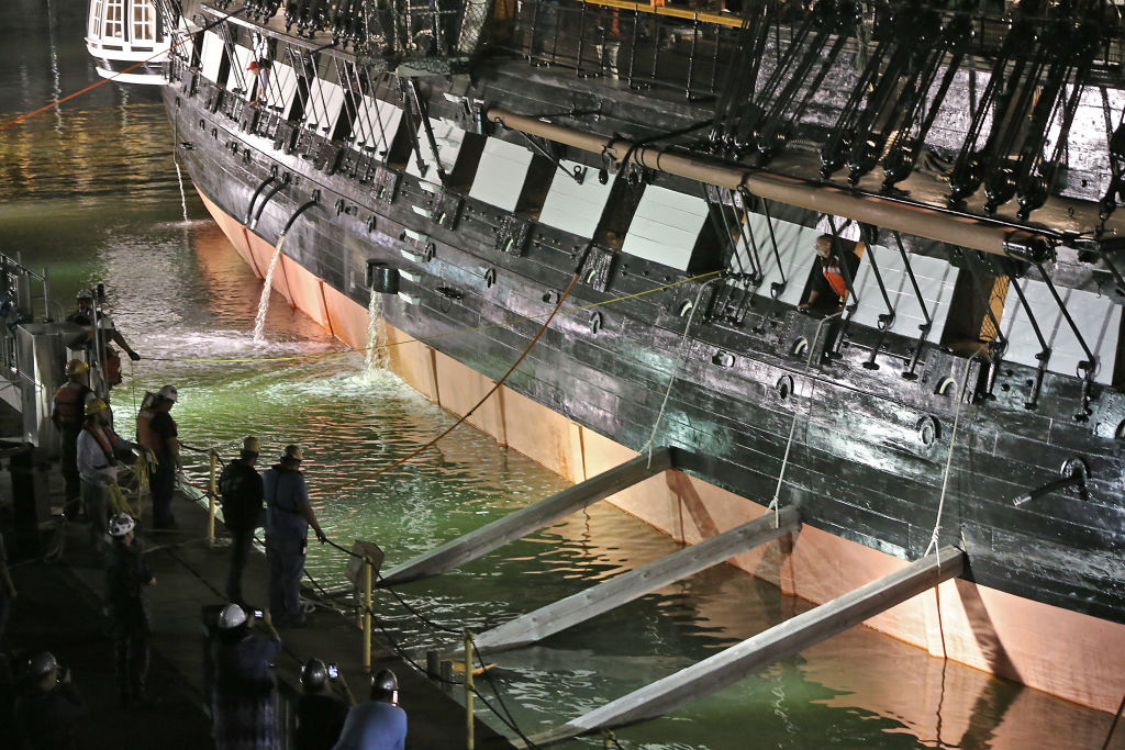 Workers remove the wale shores that had been supporting the USS Constitution.
