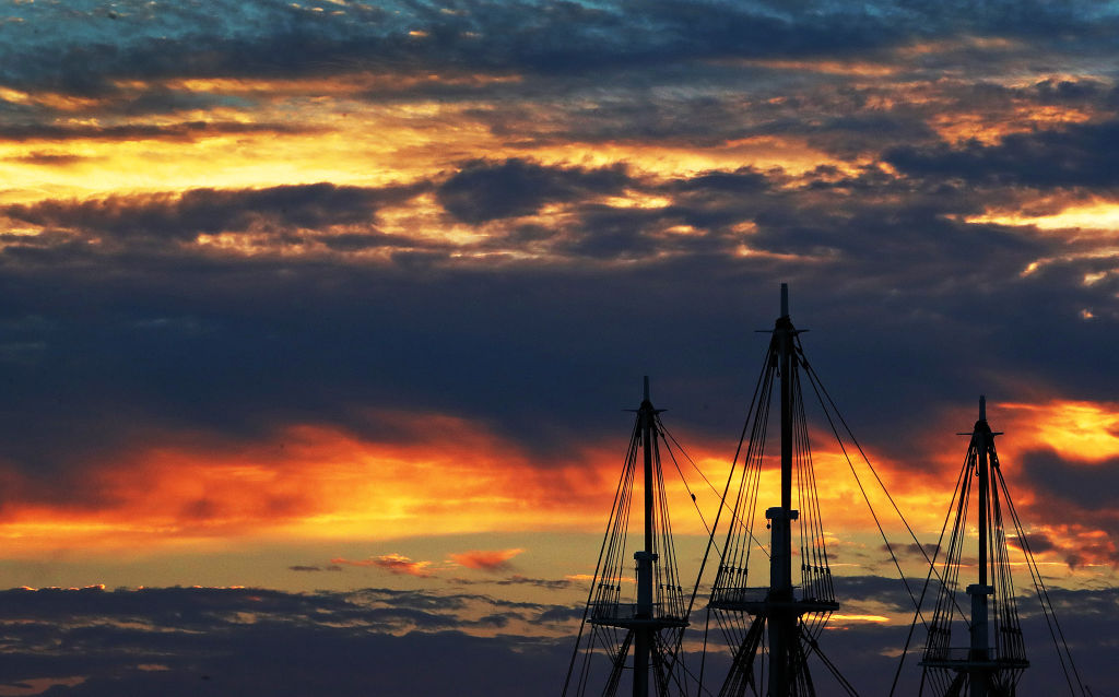 The sun set behind the USS Constitution.