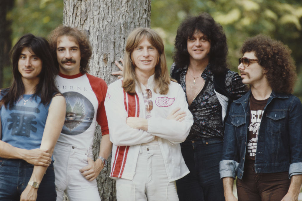 Band posing in front of a tree