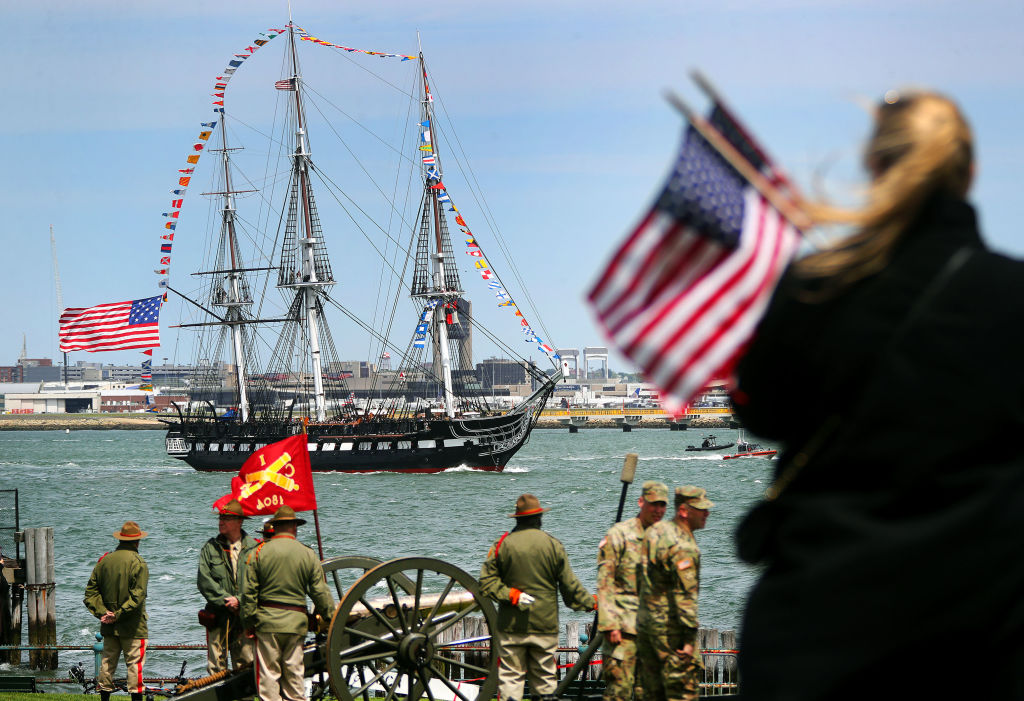 The USS Constitution is surrounded by international flags.