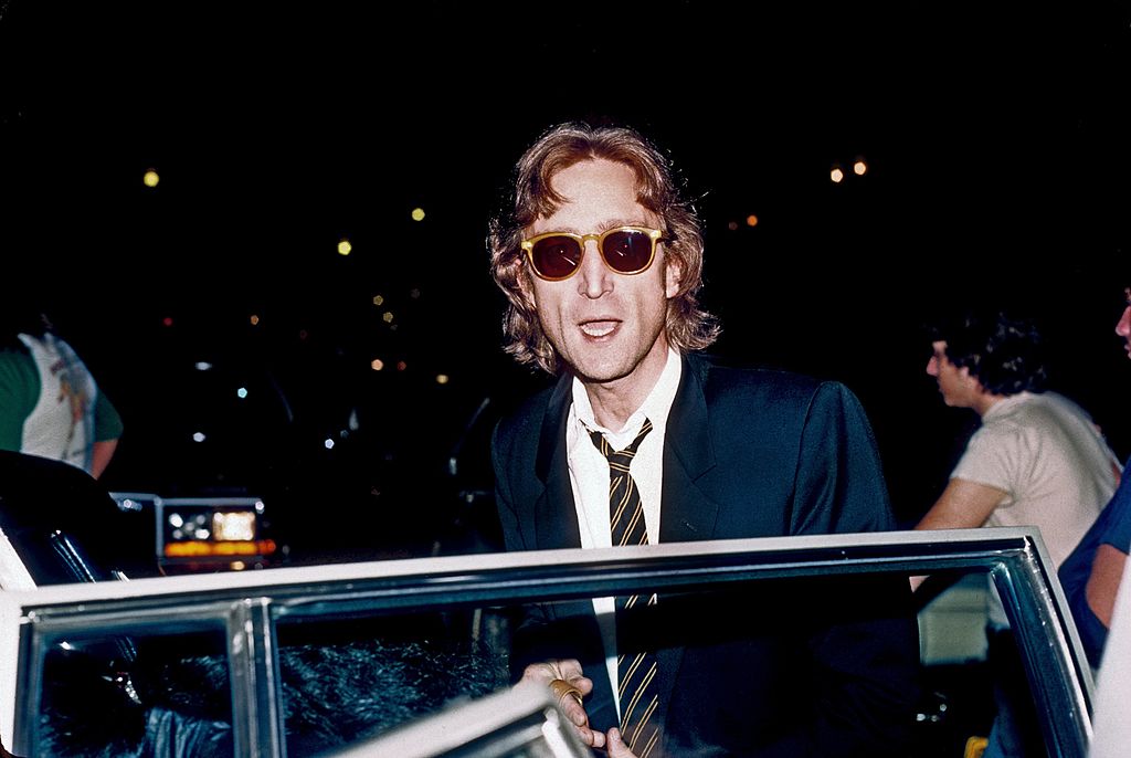 John Lennon getting into a car