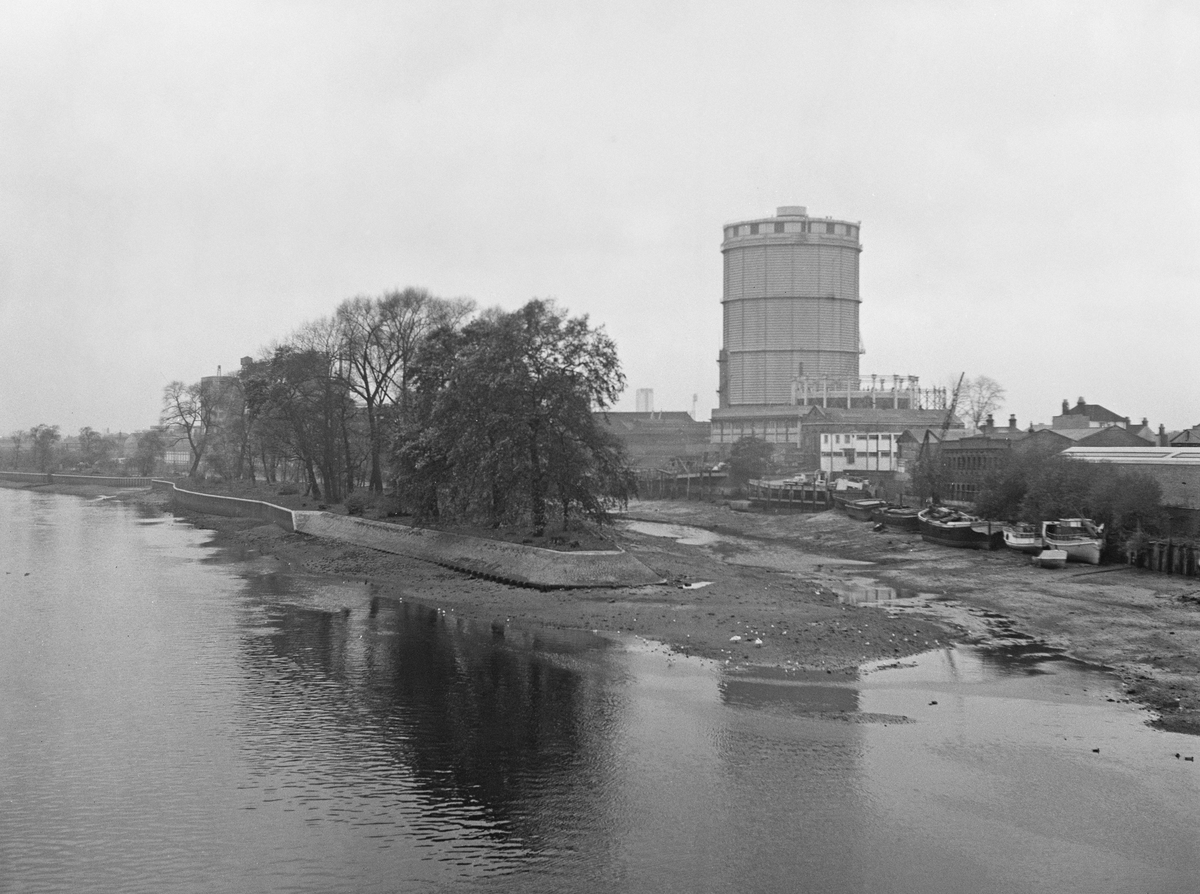 View from Kew Bridge shows north bank of the River Thames with Brentford Ait in the center, 1964.