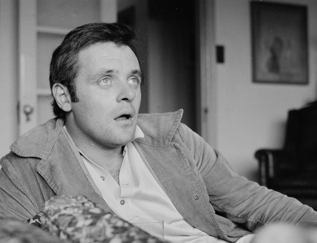 Anthony looks up with his mout ajar in a black and white photo.