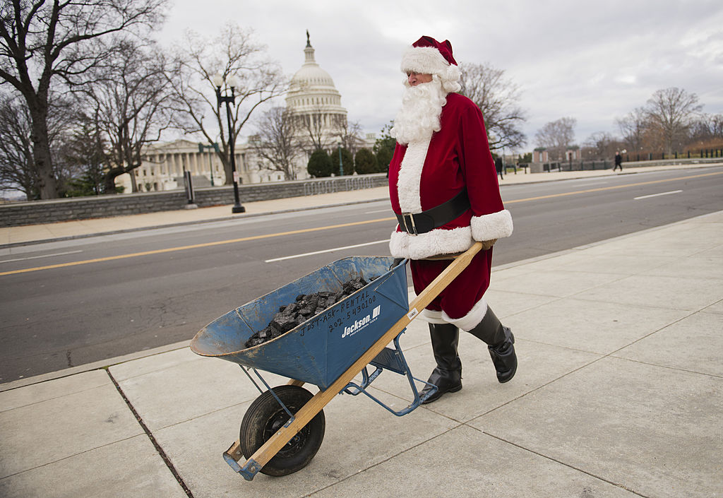 Man dressed as Santa Claus with coal 