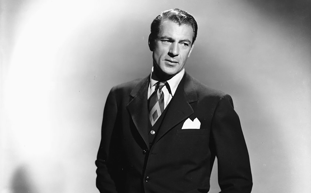 Cooper wearing a suit and tie