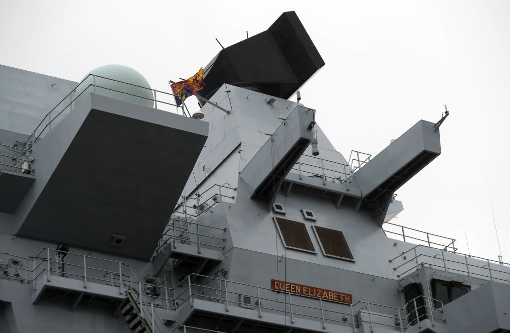 The Royal Standard flag flies above the forward tower on HMS Queen Elizabeth after her commissioning ceremony