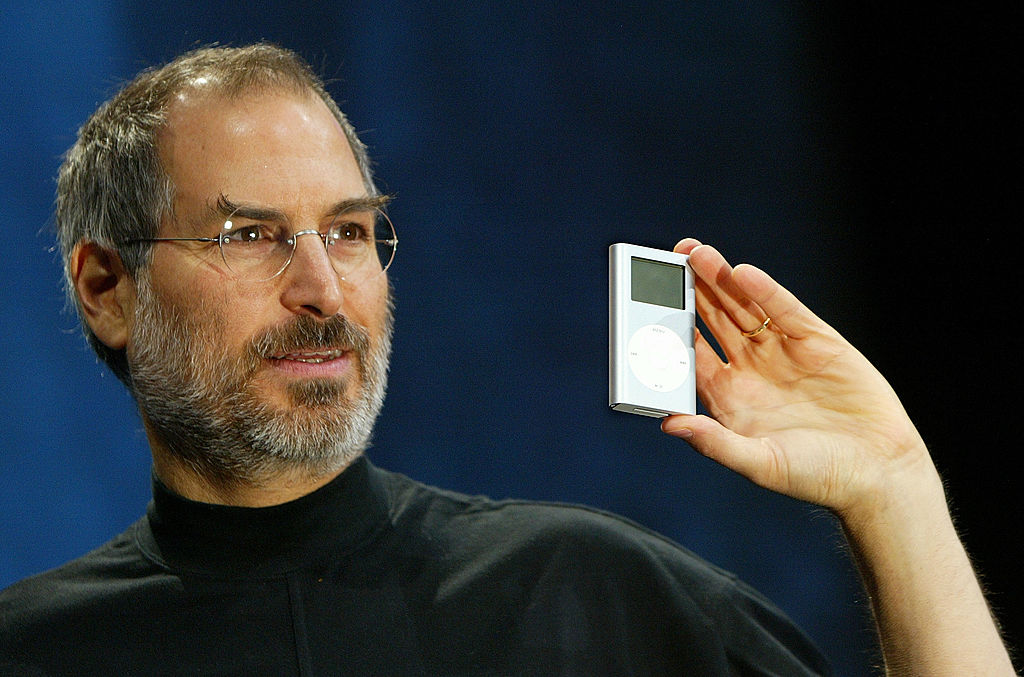 Apple CEO Steve Jobs holds a new mini iPod