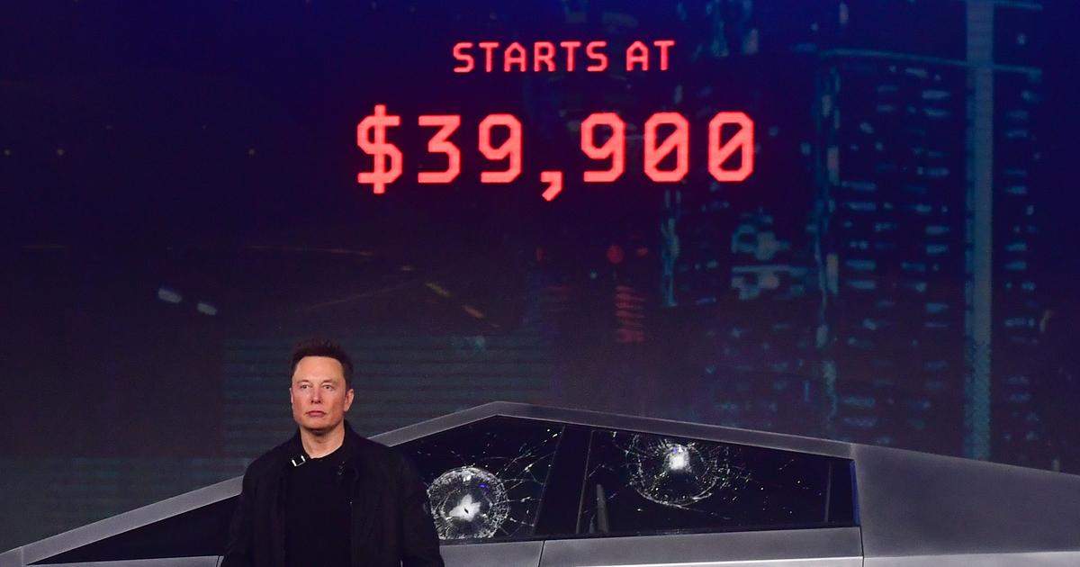 Elon Musk stands in front of the newly unveiled all-electric battery-powered Tesla's Cybertruck